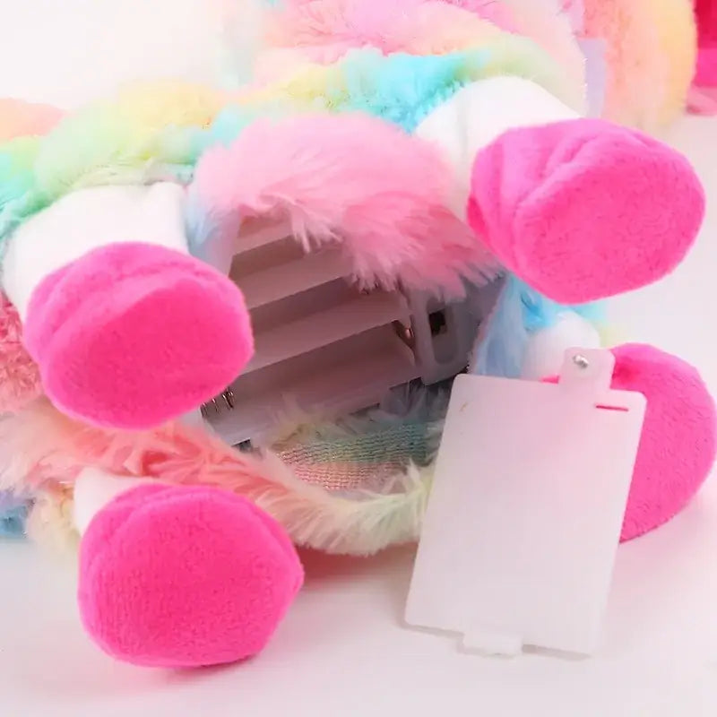 Colorful plush llama's feet showing battery compartment, perfect for interactive musical play for kids.