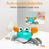 Hand-operated cute crab toy with music, featuring auto-avoidance for obstacles, perfect for engaging baby play.