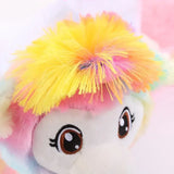 Close-up of a colorful llama toy with vibrant yellow and pink hair, featuring large expressive eyes.